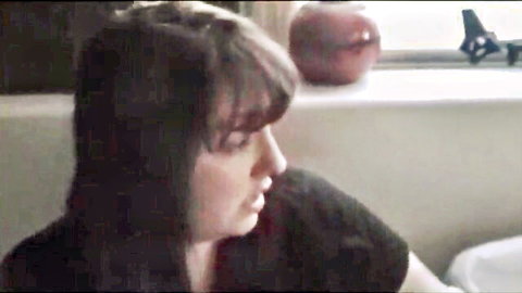 Brunette mature woman in profile, dark hair and black top, incest family teaser