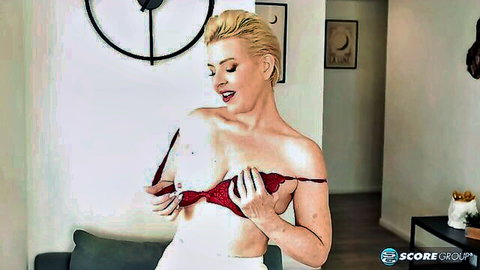 Bobbi Shay teases by pulling down red bra, exposing big breasts