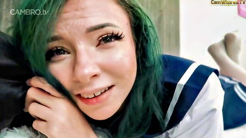 Green-haired Asian woman in sailor school uniform smiling close-up