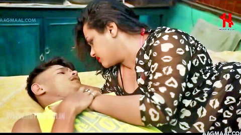 Indian chubby mommy in sheer dress kissing young man passionately
