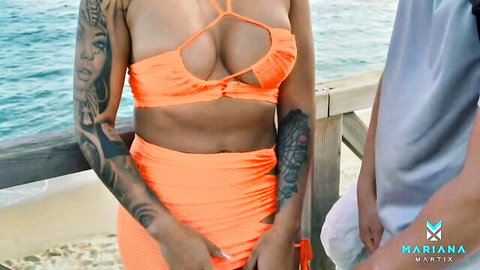 Mariana Martix in orange bikini top with deep cleavage on beach pier