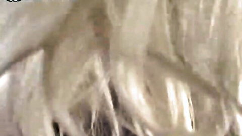 Blurry closeup of sexy blonde's flowing hair in passionate adult scene