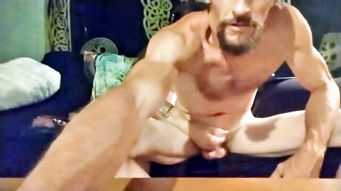 Muscular bearded stud grips his thick uncut cock in solo webcam stroke session