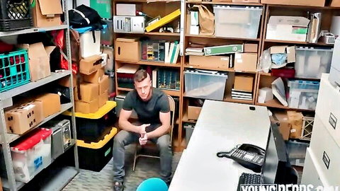 Muscular Caucasian guy in black t-shirt and jeans sitting casually