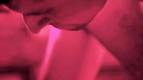 Intense horror babe passionately deep kissing man with tongues in pink neon glow