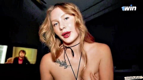 Stunning blonde bimbo topless tease with choker and olive tattoo