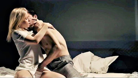 Sensual blonde in white tee passionately kissing shirtless man's neck on bed