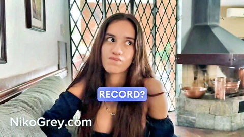 Surprised brunette teen with big tits teasing deep cleavage on couch