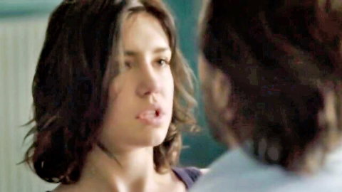 Brunette woman with open mouth facing man closely in intimate scene