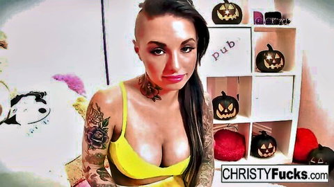 Tattooed brunette with big tits spilling from yellow bikini top poses seductively for Halloween