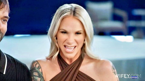 Kaci Kennedy, tattooed blonde hotwife smiling in halter dress