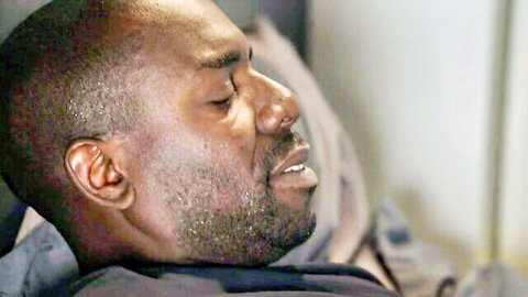 Close-up of handsome black man with beard sleeping peacefully on bed pillow