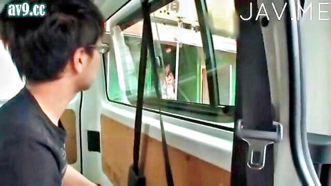 Shy Asian guy in van glancing out window during car sex tease