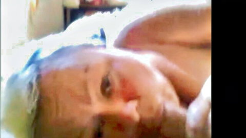 Mature Russian MILF lying topless on bed exposing saggy tits closeup