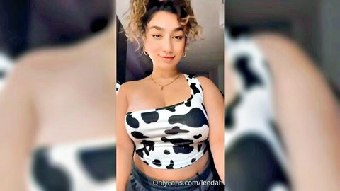 Curvy babe with huge tits teasing deep cleavage in cow print top