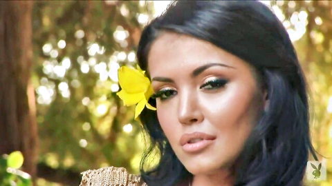 Andreea Mantea seductive pose with yellow flower in hair, outdoor Playboy shoot