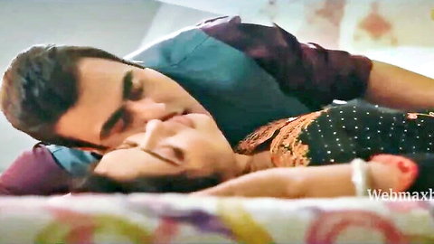 Passionate Indian couple kissing intimately in bed, Ullu web series scene