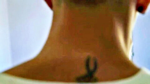 Close-up of frat guy's athletic neck and tattooed upper back