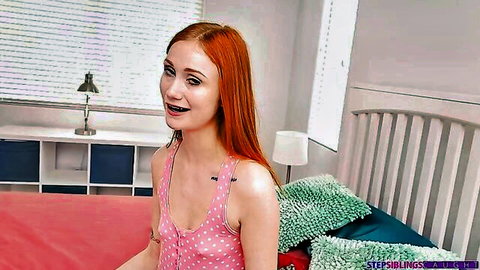 Smiling redhead stepsister in pink tank top with braces