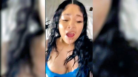 Ebony woman with wavy hair, tongue out, and cleavage in explicit tease