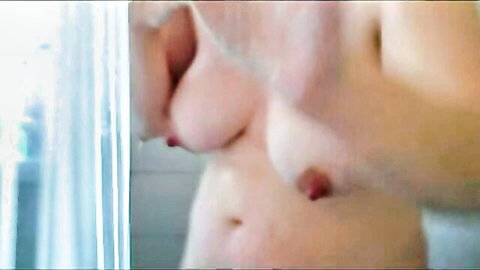 Topless mature cougar woman posing nude in bathroom, exposing breasts