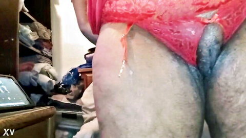 Man in red lingerie with cumshot on thighs and exposed penis