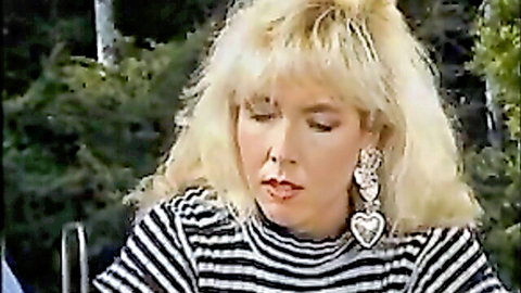 Blonde 90s sweetheart in striped sweater and heart earrings, soft tease