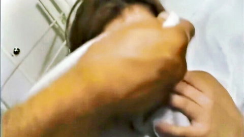 Rough hand gripping woman's face forcing mouth open in steamy bathroom