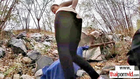Slim Thai teen bending over boyfriend in outdoor rocky woods