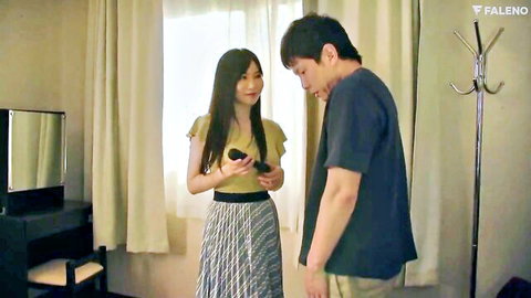 Cute Asian babe in pleated skirt chats with handsome guy holding remote indoors