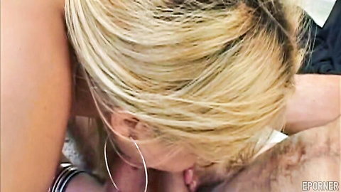 Blonde with hoop earrings eagerly sucking thick cock in close-up blowjob.