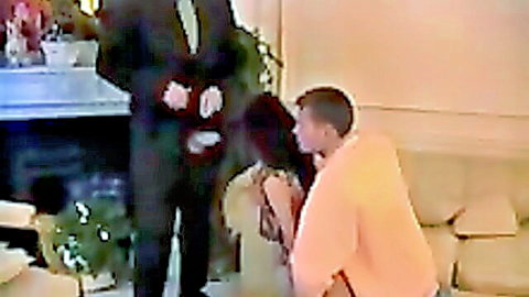 Anita Gyongy kneeling in white dress with suited man and casual guy