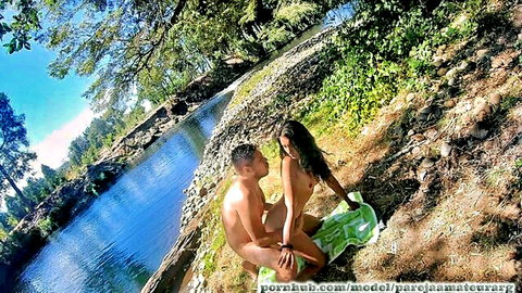 Petite naked brunette Latina straddles boyfriend's big erect cock outdoors by river