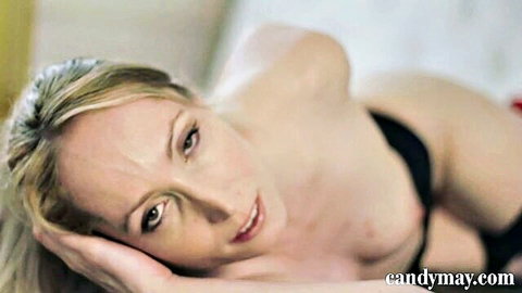 Blonde Candy May topless in black lingerie, seductive bedroom pose