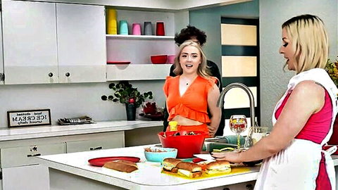 Sydney Paige and Eva Nyx in sexy aprons teasing in kitchen