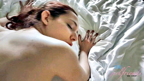 Ember Stone nude redhead lying relaxed on bed