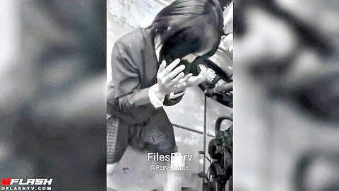 Mysterious Asian woman in suit clasping hands near engine, face explosion tease