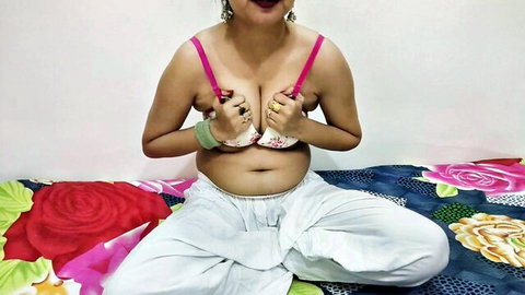 Curvy Indian woman in white bra and pants, smiling seductively