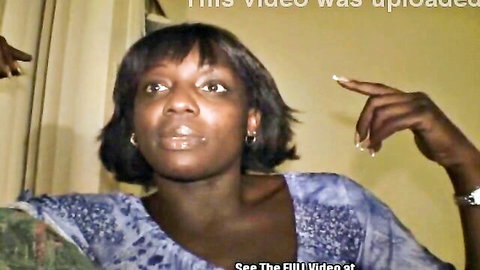 Ebony woman in blue top gesturing with long nails wide-eyed in amateur interview
