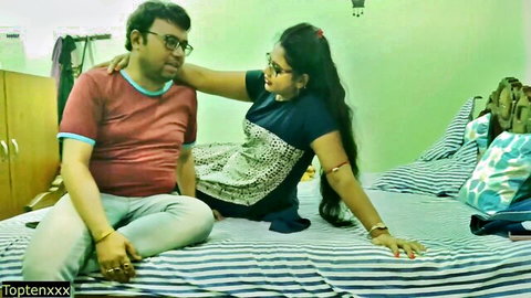 Indian couple in intimate pose on bed, woman in patterned dress, from hot cheating orgy video