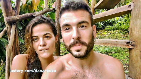 Latina couple embracing topless in Brazilian jungle wilderness