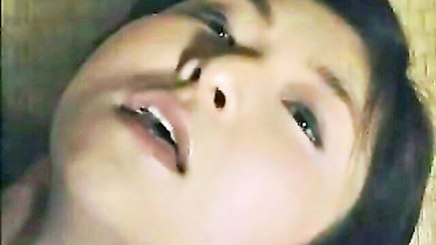Close-up of ecstatic Japanese woman with open mouth in pleasure