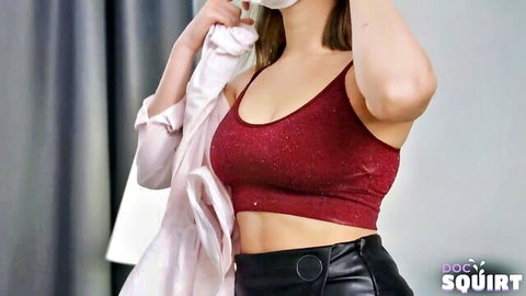 Curvy brunette babe in sparkly red bra and black leather shorts showing big tits cleavage