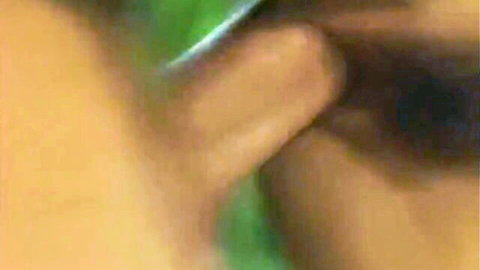 Blurry close-up of a woman's ear with green glow and skin details