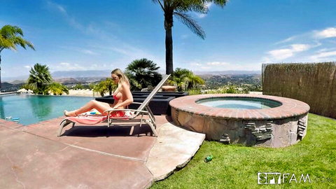 Blonde step sister in red bikini lounging by the pool