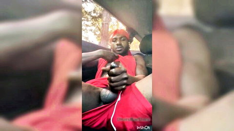 Black guy grips his thick BBC through red shorts in car seat