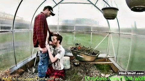 Redneck gardener receives outdoor blowjob from kneeling twink in greenhouse