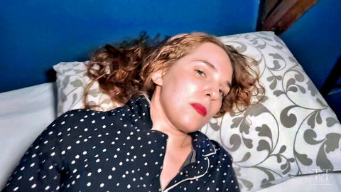Ellie Mischievous in seductive polka-dot pajamas lying on bed