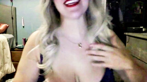 missclaranoir blonde with big tits smiling in low-cut top