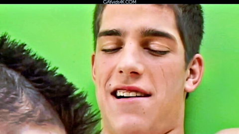 Hot young Latino twink eyes closed moaning in intense gay blowjob pleasure